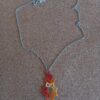 Dentelle de frivolités. Pendentif Souci en fil de coton DMC orange citrouille ombré